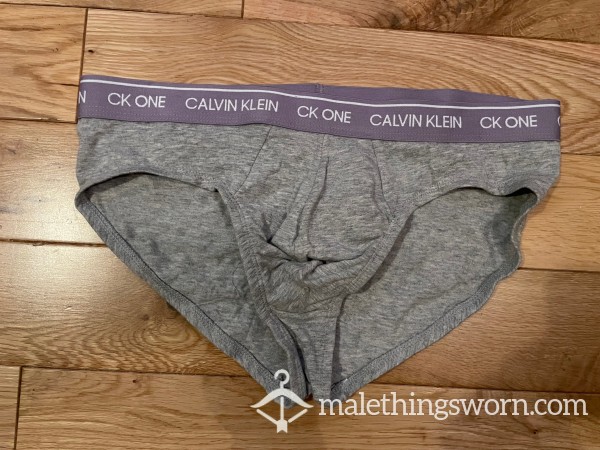 Calvin Klein CK ONE Tight Fitting Grey Hip Briefs With Lilac Logo Waistband (M)